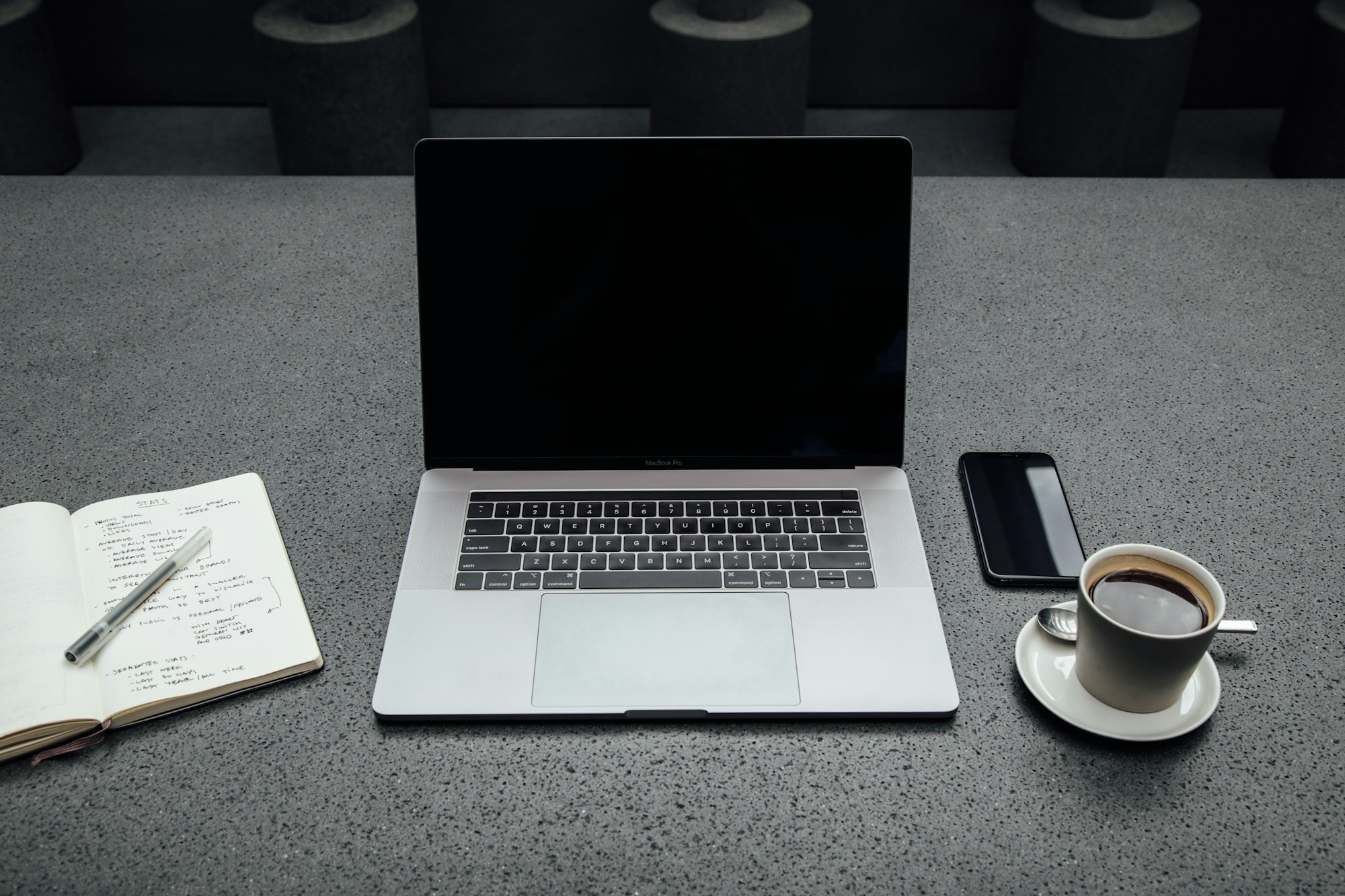 Business laptop with phone and notebook on a desk