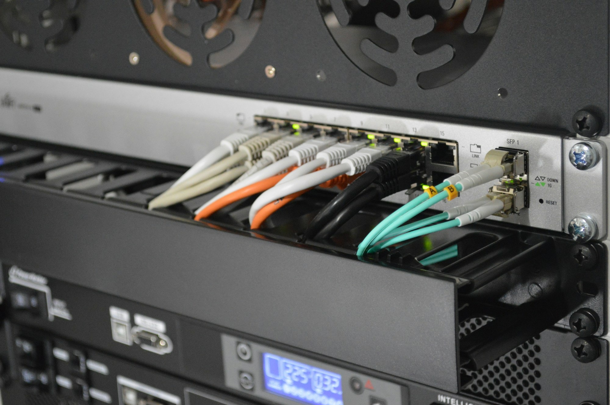 Rack-mounted network switch with ethernet and fibre cables
